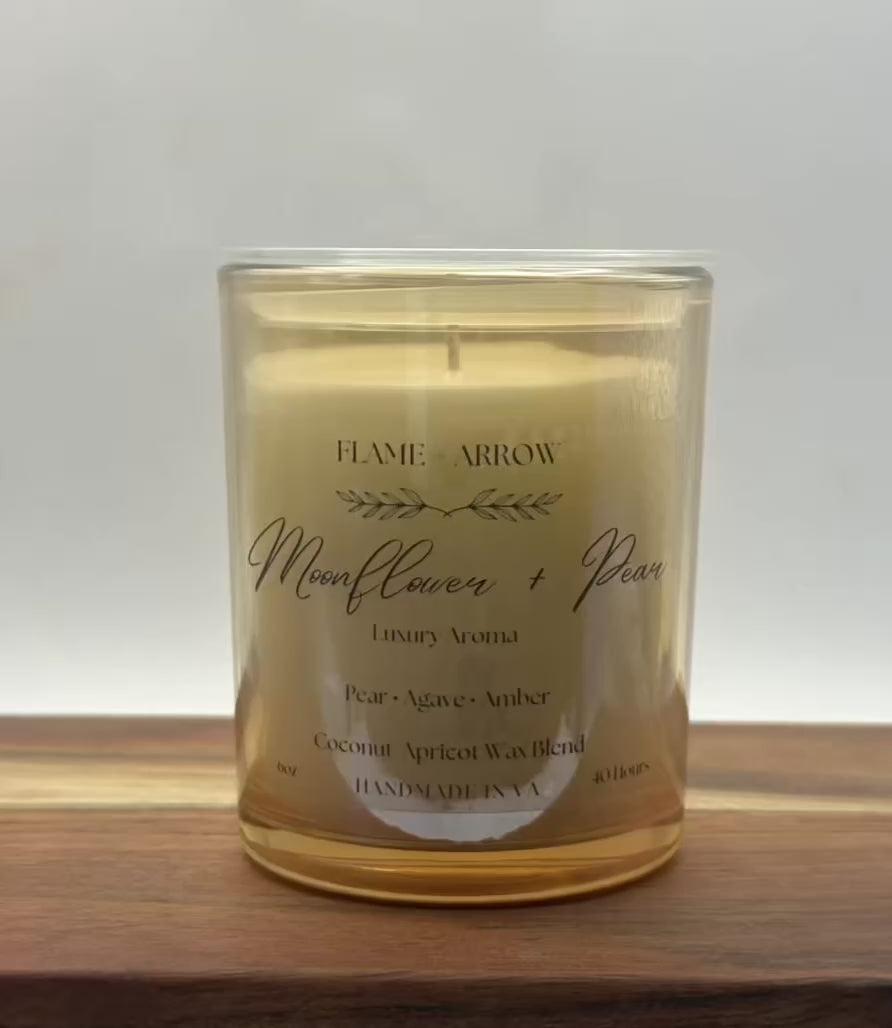 Moonflower Pear candle with lid being taken off.