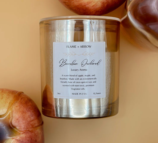 Bourbon Orchard coconut-apricot wax candle with apple elements in the background.