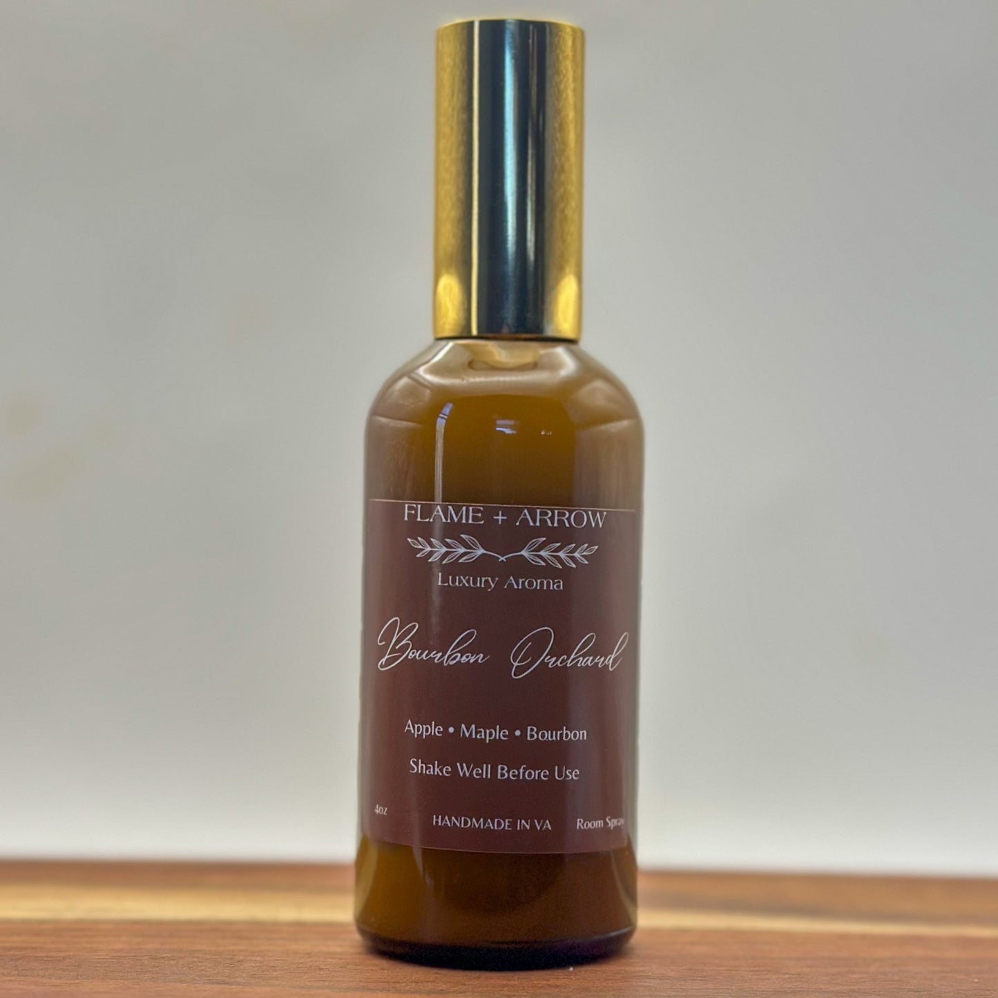 Bourbon Orchard room spray in amber glass bottle with a gold mist top.