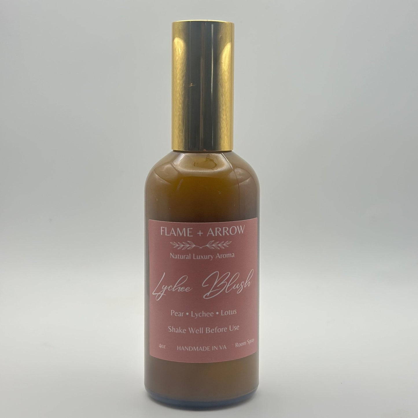 An amber bottle with gold top of Lychee Blush room spray