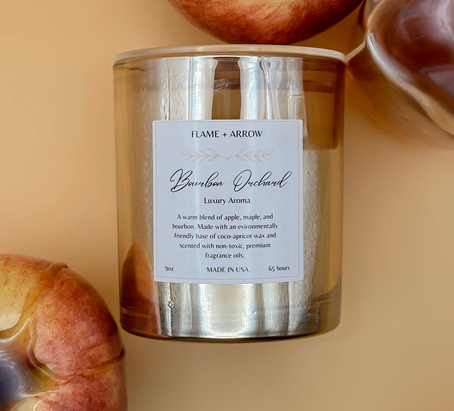 Bourbon Orchard coconut-apricot wax candle with apple elements in the background.
